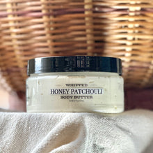 Load image into Gallery viewer, Honey Patchouli whipped body butter displayed with warm fall décor.