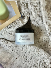 Load image into Gallery viewer, Honeysuckle Body Cream nestled in a soft, cream-colored textured blanket beside a gold tray.