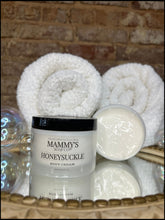 Load image into Gallery viewer, Jar of Mammy's Honeysuckle body cream with rolled towels on a textured surface