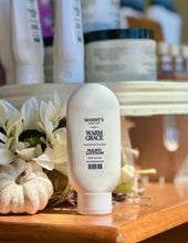 Load image into Gallery viewer, Warm Grace Hand Lotion displayed beside white flowers and a small pumpkin.
