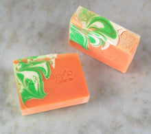 Load image into Gallery viewer, Two bars of orange, green and white soap stamped 'Mammy's Soap Co'