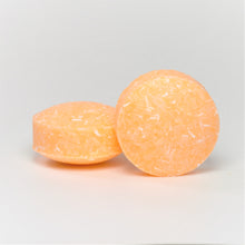Load image into Gallery viewer, two round yellow orange shampoo pucks