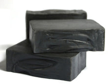 Load image into Gallery viewer, 2 jet black soap bars stacked with another in the back on a white background