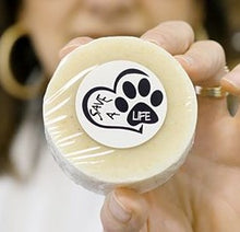 Load image into Gallery viewer, round tan pet soap with white label of heart and paw print reading Save A Life