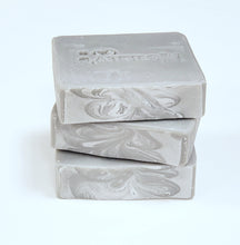 Load image into Gallery viewer, Three bars of gray soap stacked on a white surface.