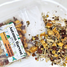 Load image into Gallery viewer, A clear plastic bag filled with dried herbal tea blend, including ingredients such as cinnamon sticks, ginger root, and rosehips. A label on the front displays 'Autumn Harvest' and the brand 'Mammy's Soap Co.
