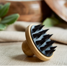 Load image into Gallery viewer, Wooden and silicone massager on a textured surface with blurred background
