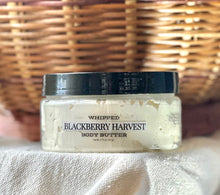Load image into Gallery viewer, Blackberry Harvest whipped body butter displayed with warm fall décor.


