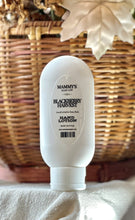 Load image into Gallery viewer, Blackberry Harvest hand lotion displayed with warm fall décor.

