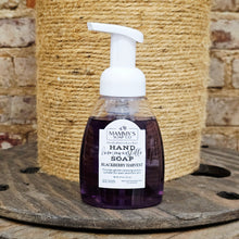 Load image into Gallery viewer, Foam hand soap bottle labeled Mammy's Soap Co Blackberry Harvest Foaming Castile Hand Soap on a wooden surface and stone wall background 
