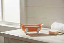 Load image into Gallery viewer, Coral bathtub soap dish with white legs on a farmhouse bathroom counter
