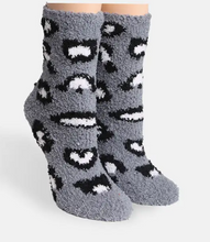 Load image into Gallery viewer, A pair of plush, fuzzy crew socks in a heather gray color, featuring a black and white leopard print pattern, shown on a light gray background.
