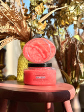Load image into Gallery viewer, Haughty Sugar Body Polish displayed open on a red wooden table surrounded by plants and fall décor.
