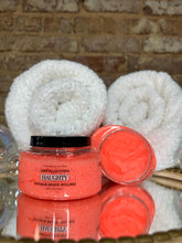 Load image into Gallery viewer, Bright orange body scrubs with white towels on a brick surface

