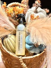 Load image into Gallery viewer, Honey Patchouli luxury body oil displayed in a fall basket with pumpkins and flowers.

