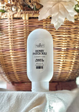 Load image into Gallery viewer, Honey Patchouli hand lotion displayed with warm fall décor.

