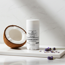 Load image into Gallery viewer, Mammy's Soap Co. deodorant stick with a half-coconut and lavender flowers on a white surface.
