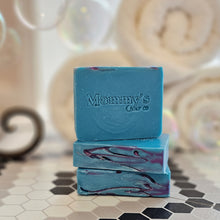 Load image into Gallery viewer, three bars of blue soap on tiled floor with white rolled towels in background
