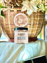 Load image into Gallery viewer, Rose Gold foaming body scrub displayed with warm fall décor.

