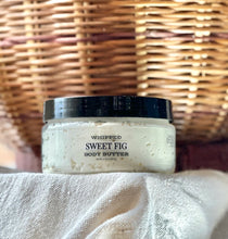 Load image into Gallery viewer, Sweet Fig whipped body butter displayed with warm fall décor.

