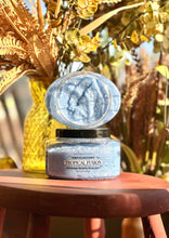 Load image into Gallery viewer, Tropical Fusion Sugar Body Polish displayed open on a red wooden table surrounded by plants and fall décor.
