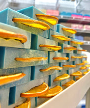 Load image into Gallery viewer, Stack of blue soap with orange slices 
