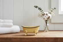 Load image into Gallery viewer, Yellow bathtub-shaped soap dish with black rim on wood surface with white towels and floral arrangement
