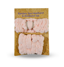 Load image into Gallery viewer, Pink packaged bamboo spa headband and wristband set on a beige background
