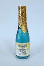 Load image into Gallery viewer, Champagne bottle filled with clear blue bubble bath topped with gold foil over cap.
