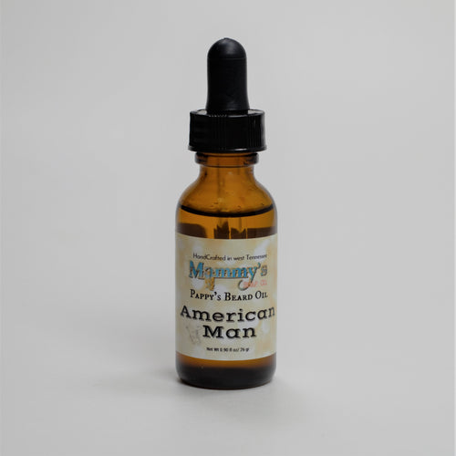 American man handcrafted natural beard oil in labeled amber glass bottle with dropper
