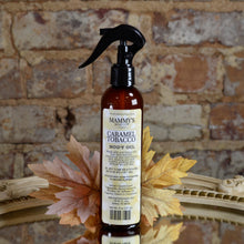 Load image into Gallery viewer, amber spray bottle of caramel tobacco body oil with fall background
