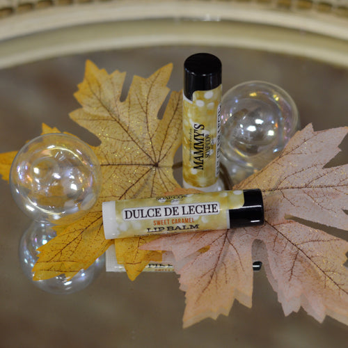 2 lip balm tubes of dulce de leche with fall background