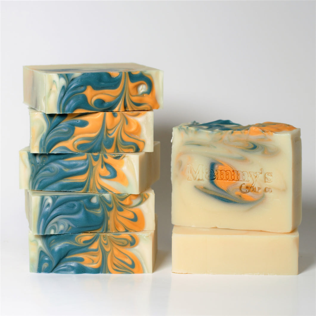 7 cream colored handmade soap bars with yellow and green swirls stamped Mammy's Soap Co