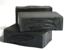 Load image into Gallery viewer, 2 jet black soap bars stacked with another in the back on a white background
