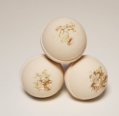 ivory bath bomb topped with rolled oats scented with granola blended with fresh oats, golden honey and vanilla bean