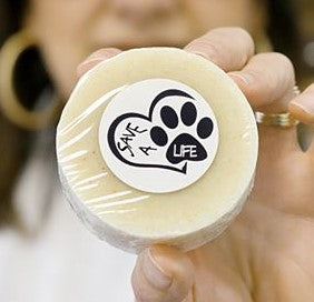 round tan pet soap with white label of heart and paw print reading Save A Life