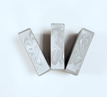 Load image into Gallery viewer, Three bars of gray soap tops on a white surface.
